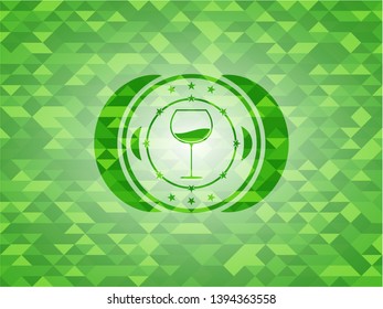 wine cup icon inside green emblem with mosaic background