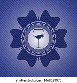wine cup icon inside jean or denim emblem or badge background