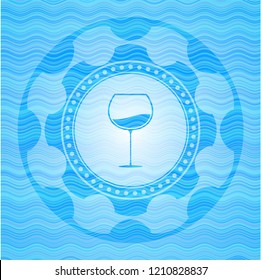 wine cup icon inside light blue water wave badge background.