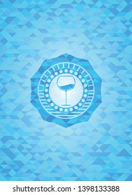 wine cup icon inside light blue emblem with mosaic background