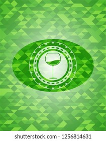 wine cup icon inside realistic green emblem. Mosaic background