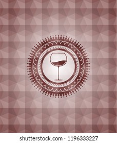 wine cup icon inside red seamless geometric badge.