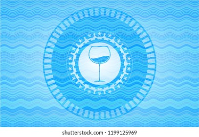 wine cup icon inside sky blue water wave badge background.