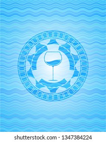 wine cup icon inside sky blue water wave style emblem.