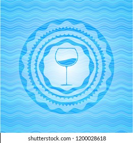 wine cup icon inside water representation badge background.