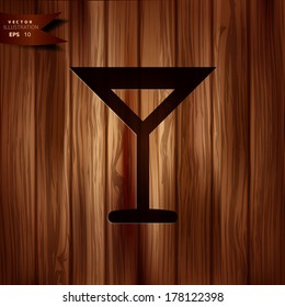 Wine glass web icon. Wooden background.