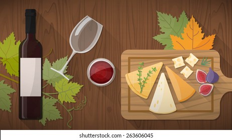 Wine tasting with delicious appetizers, cheese and fruit on a rustic chopping board, red wine glass on a wooden table top view