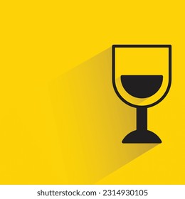 wineglass with shadow on yellow background