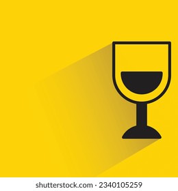 wineglass with shadow on yellow background