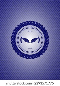 wings icon inside badge with denim texture. 