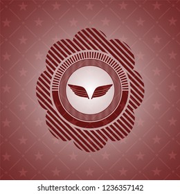wings icon inside badge with red background