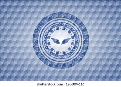 wings icon inside blue emblem or badge with geometric pattern background.