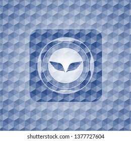 wings icon inside blue emblem or badge with abstract geometric polygonal pattern background.