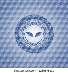 wings icon inside blue hexagon emblem.