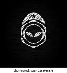 wings icon inside chalkboard emblem on black board