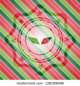 wings icon inside christmas style emblem.