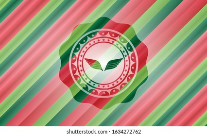 wings icon inside christmas style emblem.