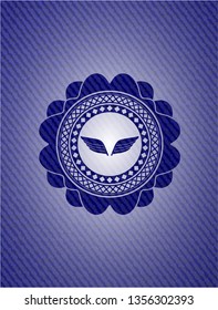 wings icon inside denim background