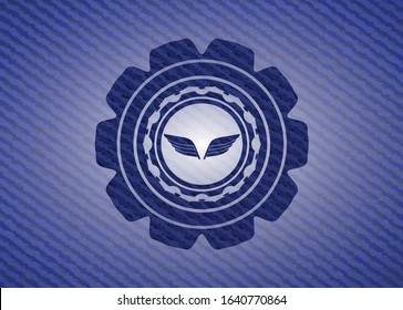 wings icon inside emblem with jean background