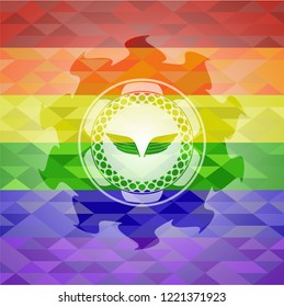 wings icon inside emblem on mosaic background with the colors of the LGBT flag