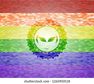 wings icon inside emblem on mosaic background with the colors of the LGBT flag