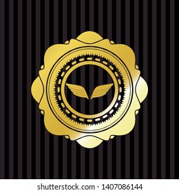wings icon inside gold badge or emblem