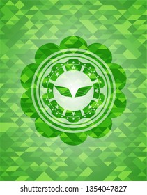 wings icon inside green mosaic emblem