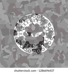 wings icon inside grey camo texture