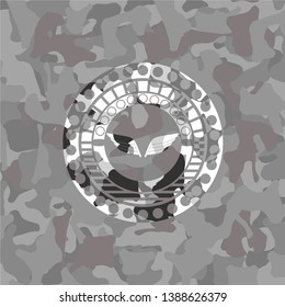 wings icon inside grey camo emblem
