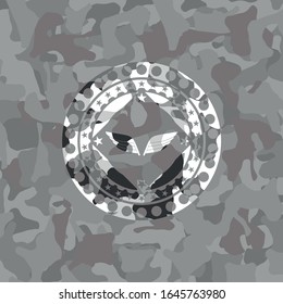 wings icon inside grey camo texture