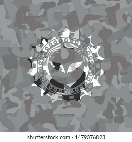 wings icon inside grey camouflage emblem
