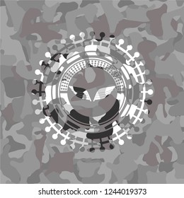 wings icon inside grey camouflaged emblem