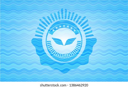 wings icon inside light blue water style emblem.