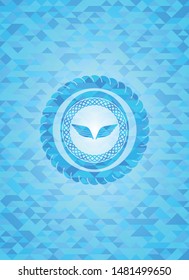 wings icon inside light blue emblem with triangle mosaic background