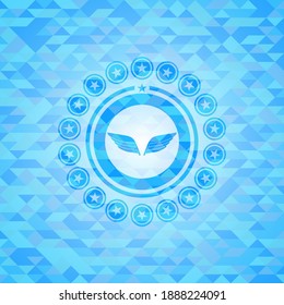 wings icon inside light blue emblem. Mosaic background. 