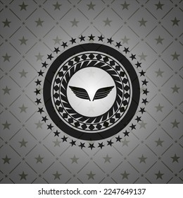 wings icon inside realistic black emblem. 