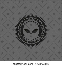 wings icon inside realistic dark emblem