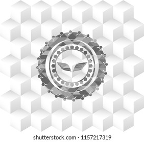 wings icon inside realistic grey emblem with geometric cube white background