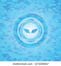 wings icon inside realistic sky blue mosaic emblem