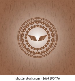 wings icon inside realistic wood emblem