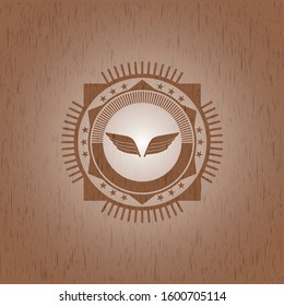 wings icon inside realistic wooden emblem