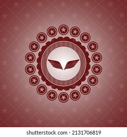 icono de alas dentro del icono o emblema rojo. 