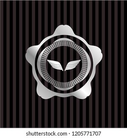 wings icon inside silvery badge or emblem