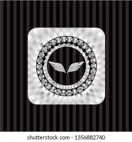 wings icon inside silvery emblem or badge