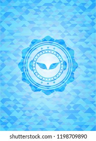 wings icon inside sky blue emblem. Mosaic background