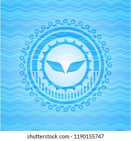 wings icon inside water concept emblem.