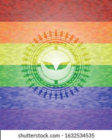 wings icon on mosaic background with the colors of the LGBT flag