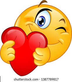 Winking emoticon emoji  hugging a red heart