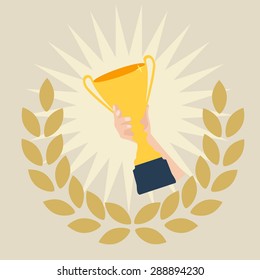 A winners hand with a golden cup