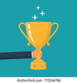 Winning cup in hand. Gold trophy. Symbol of success, winning, championship. Award bowl. Vector illustration flat design. Isolated on background. Leadership concept.